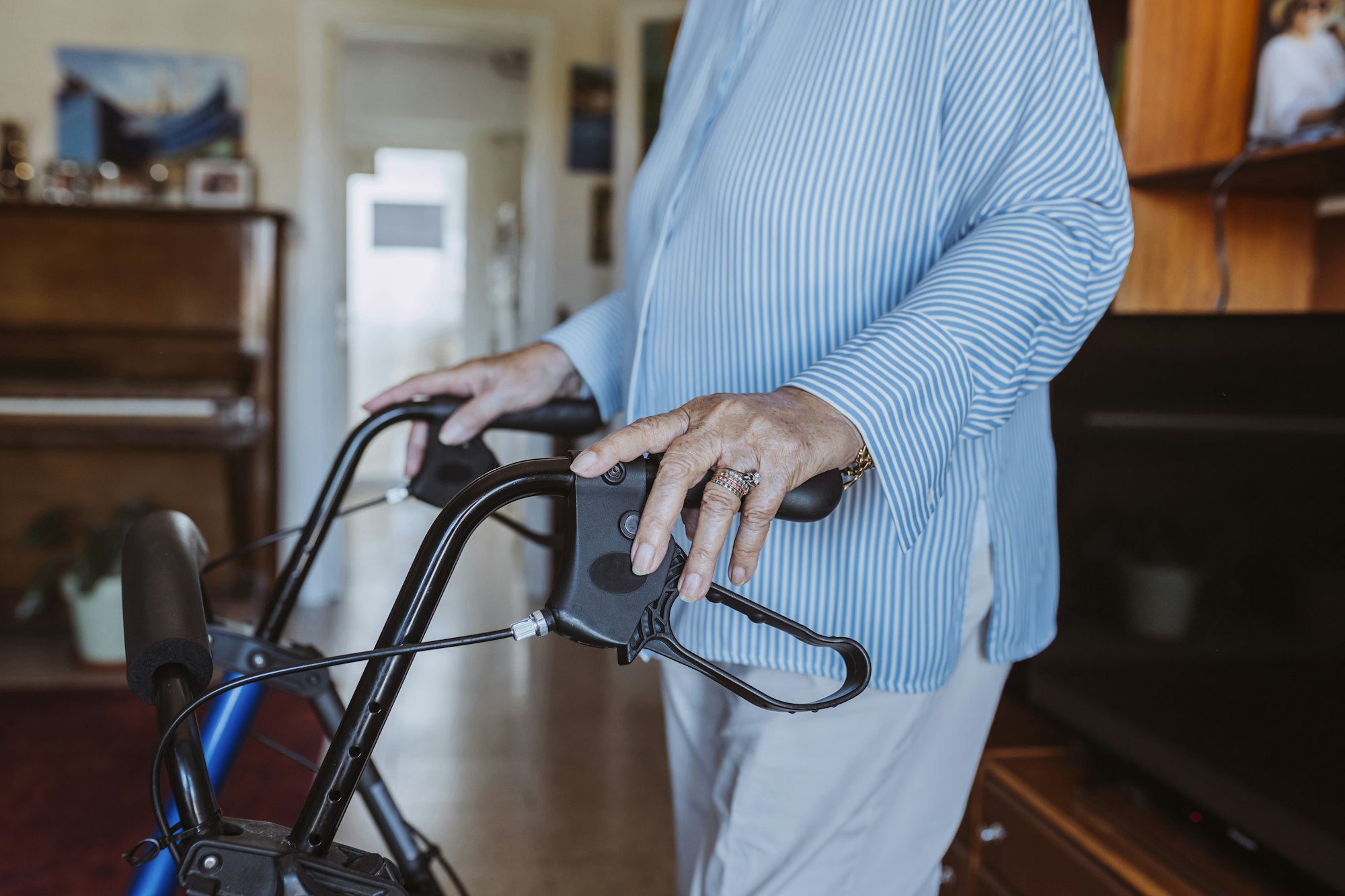 Senior grandmother using walker indoors