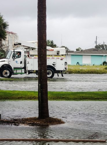 Transportation and logistics after hurricane damage on water logged roads at the beach community.